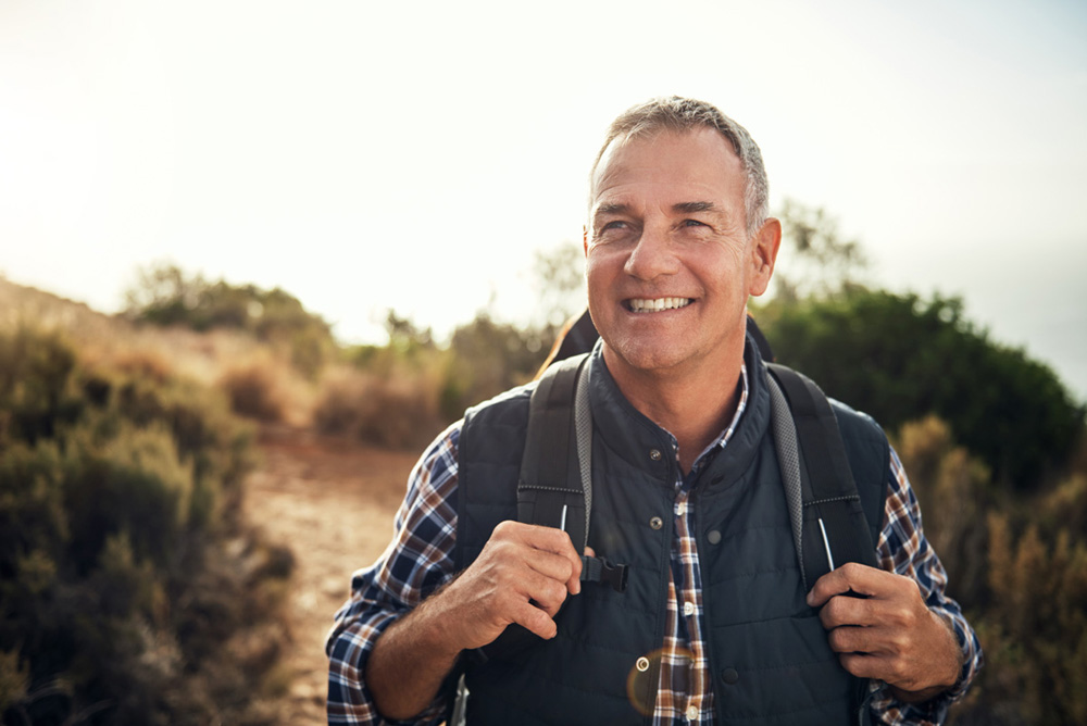 Man carrying backpack while hiking