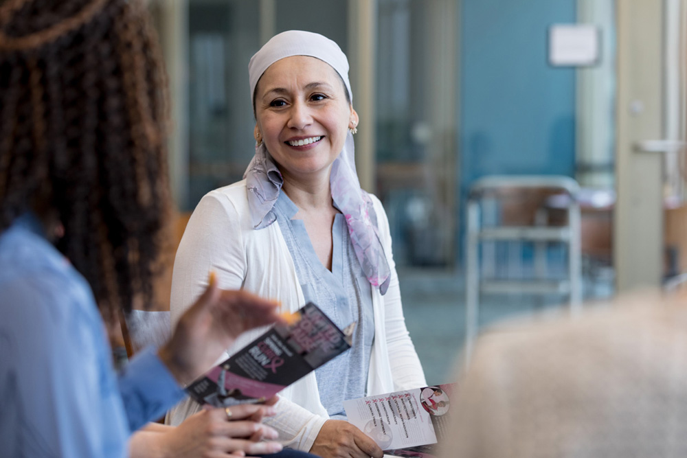 A beautiful smile lights up the face of a breast cancer survivor.