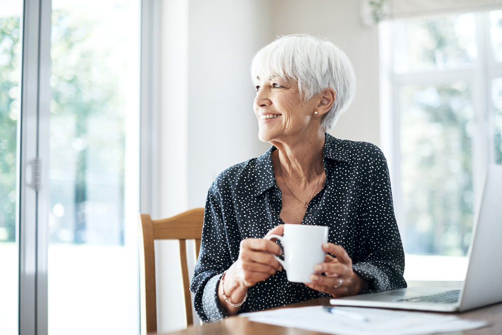 Cropped shot of a senior woman going through her finances while sitting at the dining room table